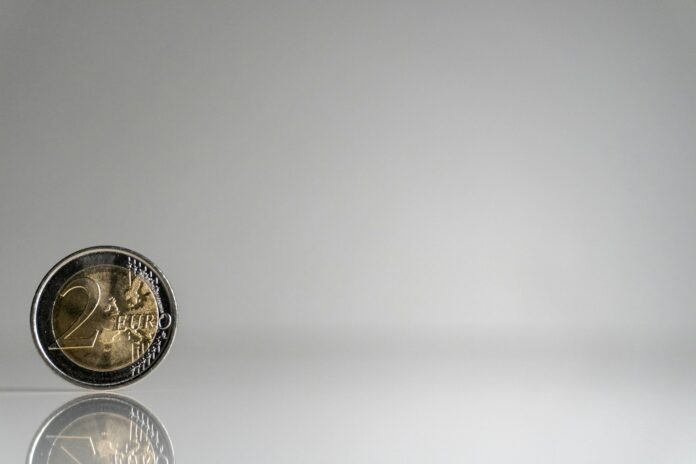 a close up of a coin on a reflective surface