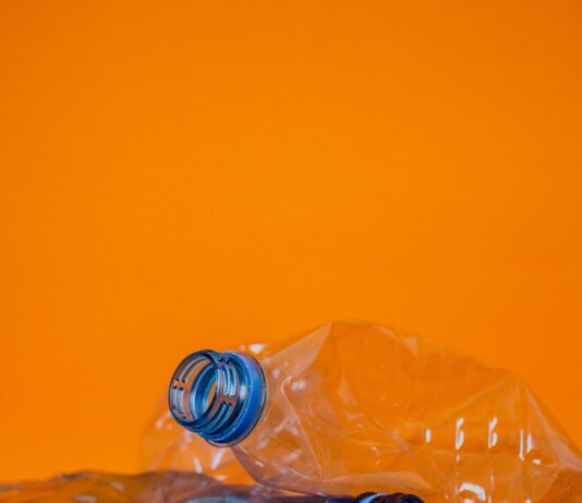 “플라스틱 줄이기, 작은 실천으로 건강 지키는 비결” blue plastic bottle on orange surface