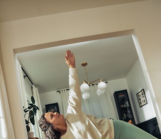 달라진 여성 건강관리, 작은 실천이 만드는 큰 변화 A woman does a yoga pose on a mat.